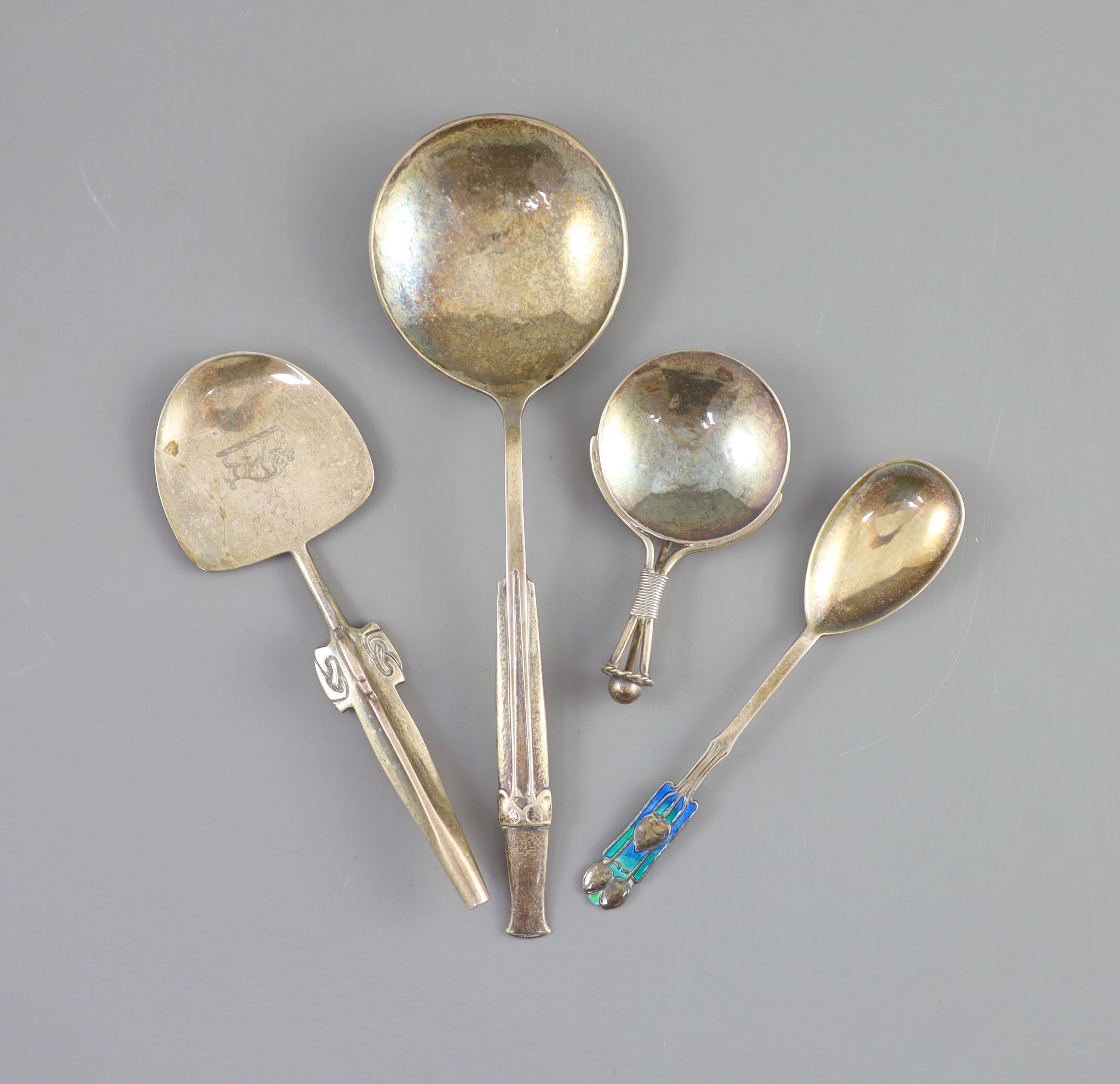 Two stylish Edwardian Art Nouveau Liberty & Co Cymric silver spoons, Birmingham, 1904, largest 18.6cm and two other spoons